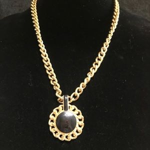 Black  medallion with gold chain